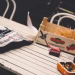 brown ceramic ashtray on white wooden picnic table
